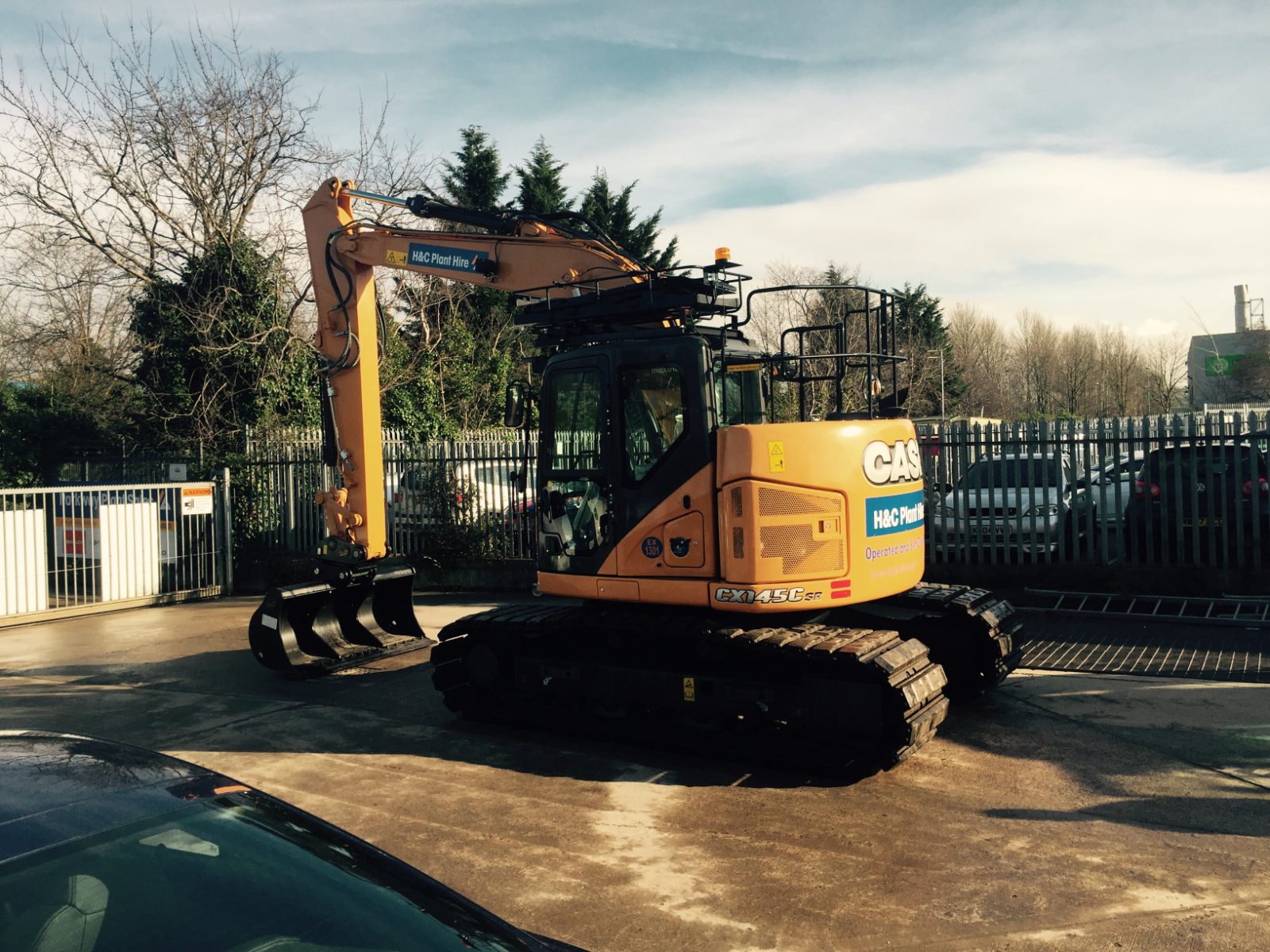 CASE tracked excavator parked beside the yard gates