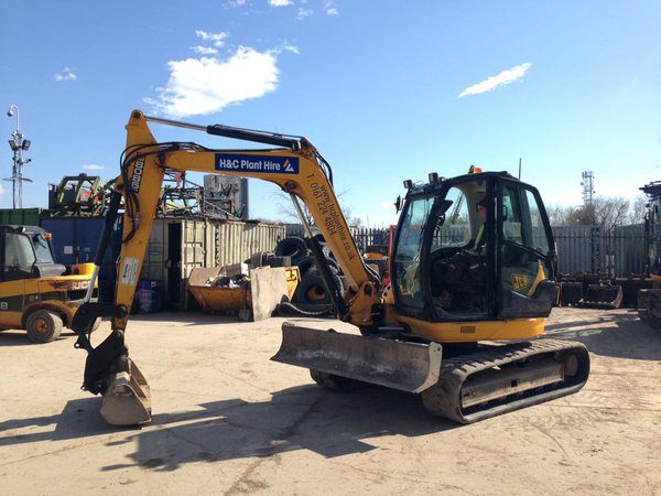 Yellow tracked excavator parked in the H&C yard