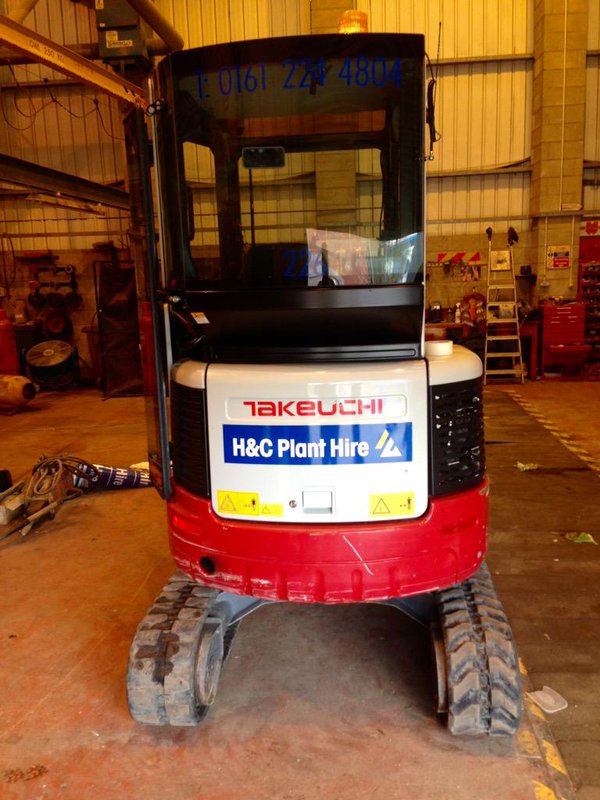 Rear view of a Takeuchi mini excavator with H&C Plant Hire signage