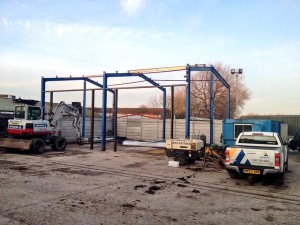 Steel frame of the new workshop under construction in the yard