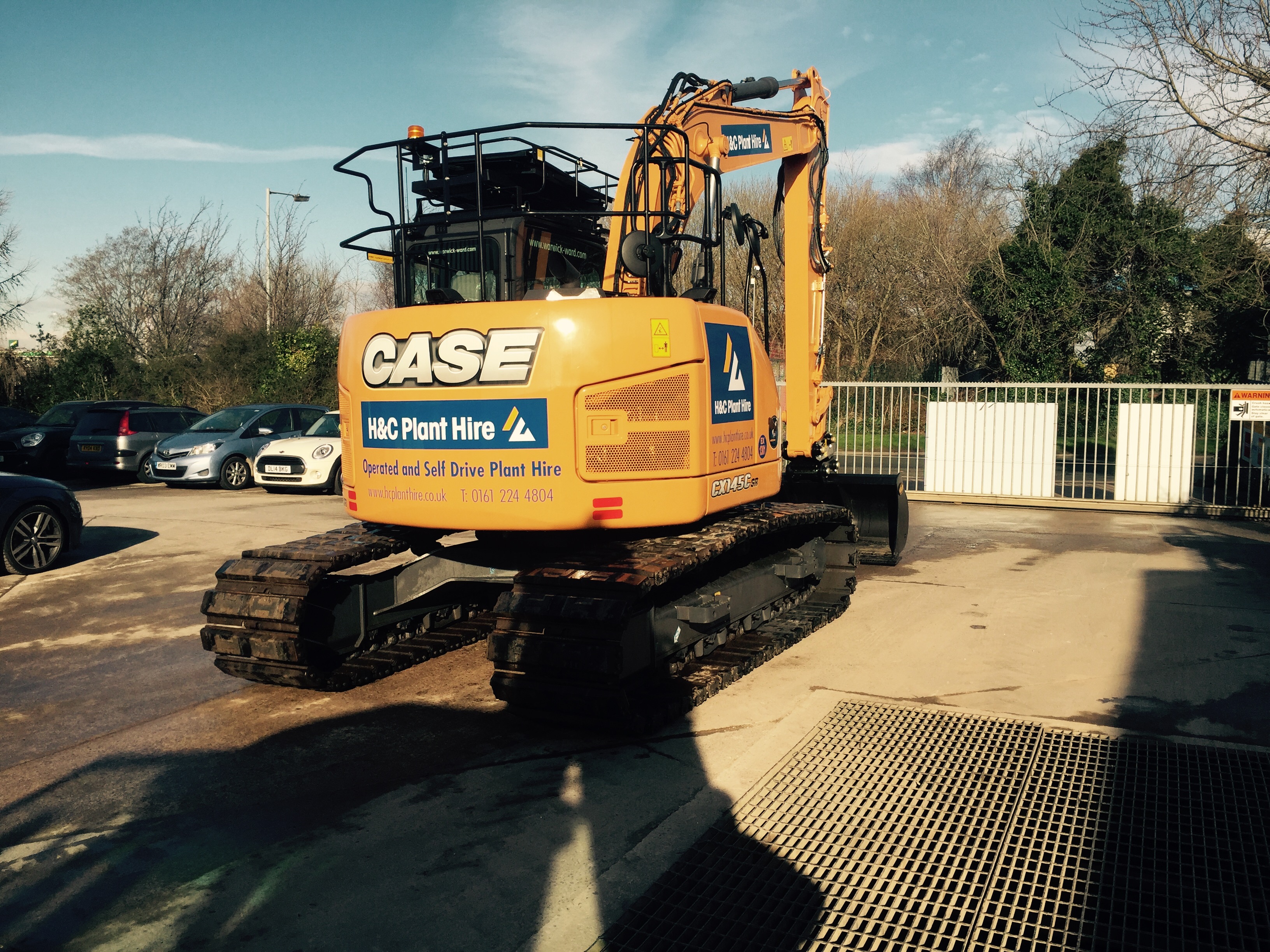 Rear three-quarter view of a CASE tracked excavator in the yard